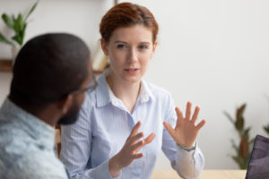 Woman in meeting with male discussing why she should have a raise