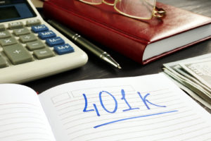 401K planning with notebook and calculator