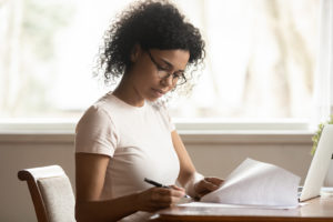 Focused women reading paperwork at desk